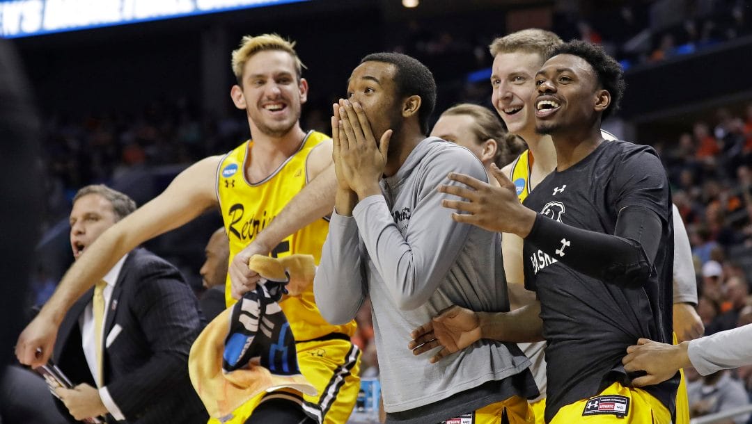 UMBC players celebrate a teammate's basket during the second half against Virginia i a first-round game in the NCAA men's college basketball tournament in Charlotte, N.C.