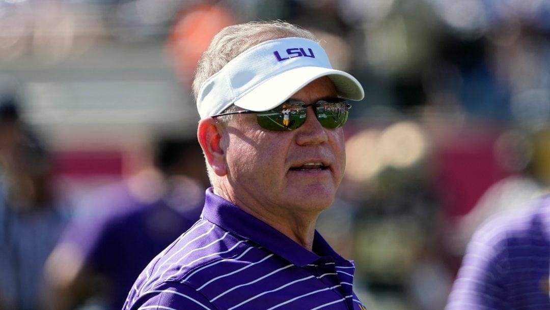 LSU head coach Brian Kelly watches players warm up before the Citrus Bowl NCAA football game against Purdue, Monday, Jan. 2, 2023, in Orlando, Fla.