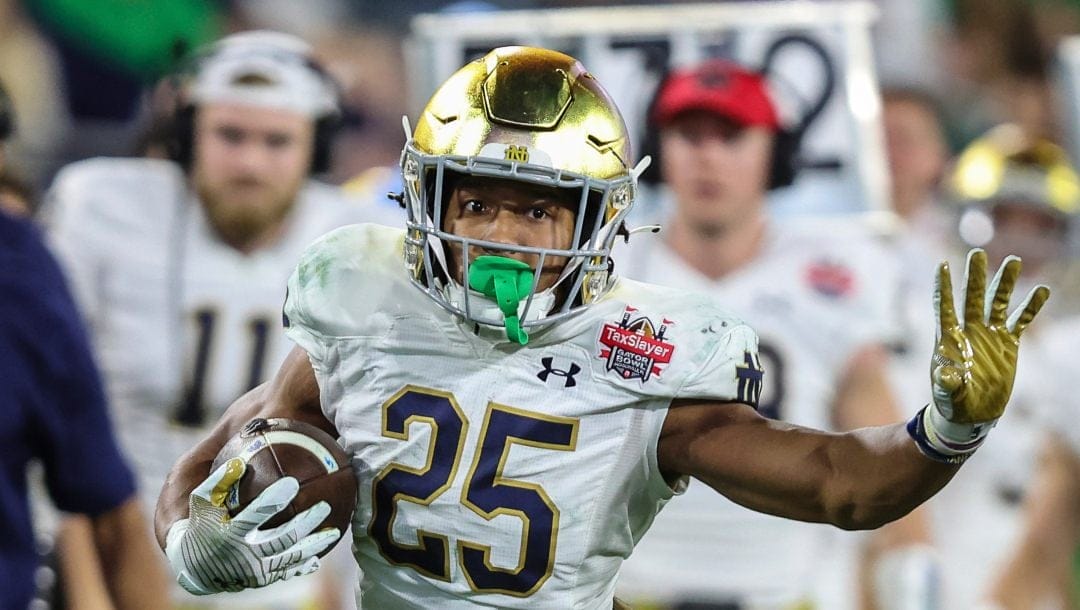 Notre Dame running back Chris Tyree (25) runs the ball during the second half of the Gator Bowl NCAA college football game against South Carolina on Friday, Dec. 30, 2022, in Jacksonville, Fla. Notre Dame defeated South Carolina 45-38.