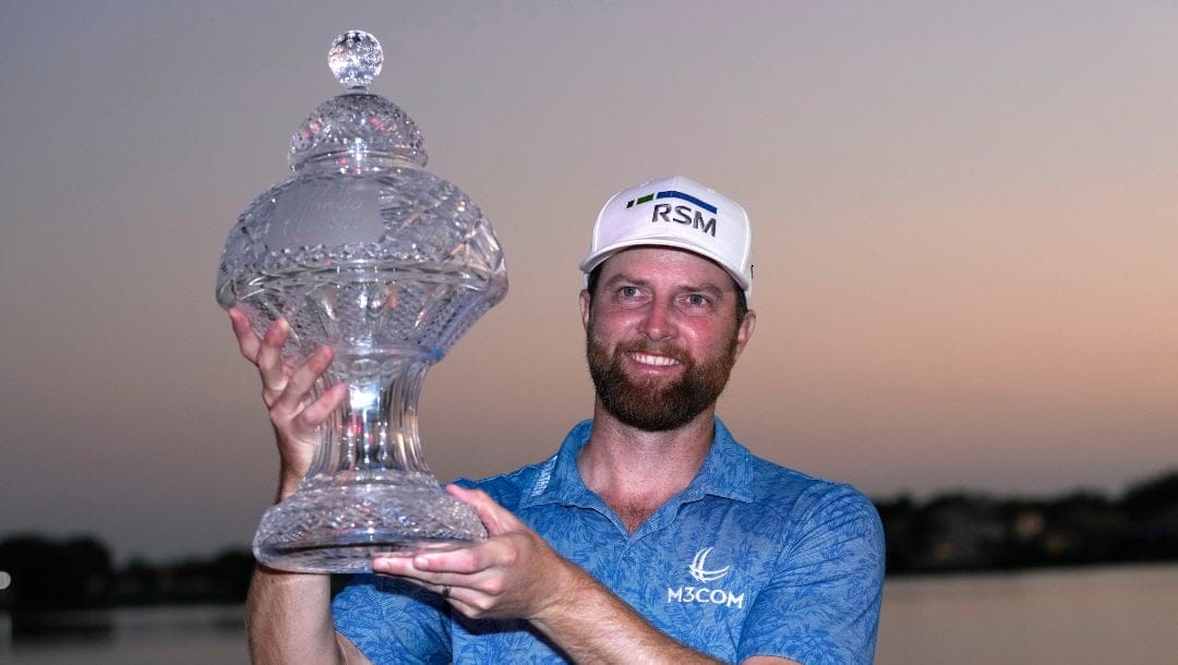 Chris Kirk holds the trophy after winning the Honda Classic golf tournament in a playoff against Eric Cole, Sunday, Feb. 26, 2023, in Palm Beach Gardens, Fla.