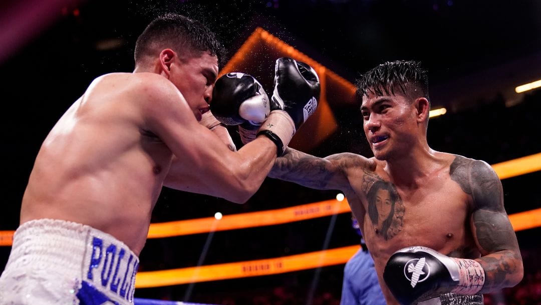 Mark Magsayo, right, of the Philippines, hits Julio Ceja, of Mexico, in a featherweight boxing match Saturday, Aug. 21, 2021.