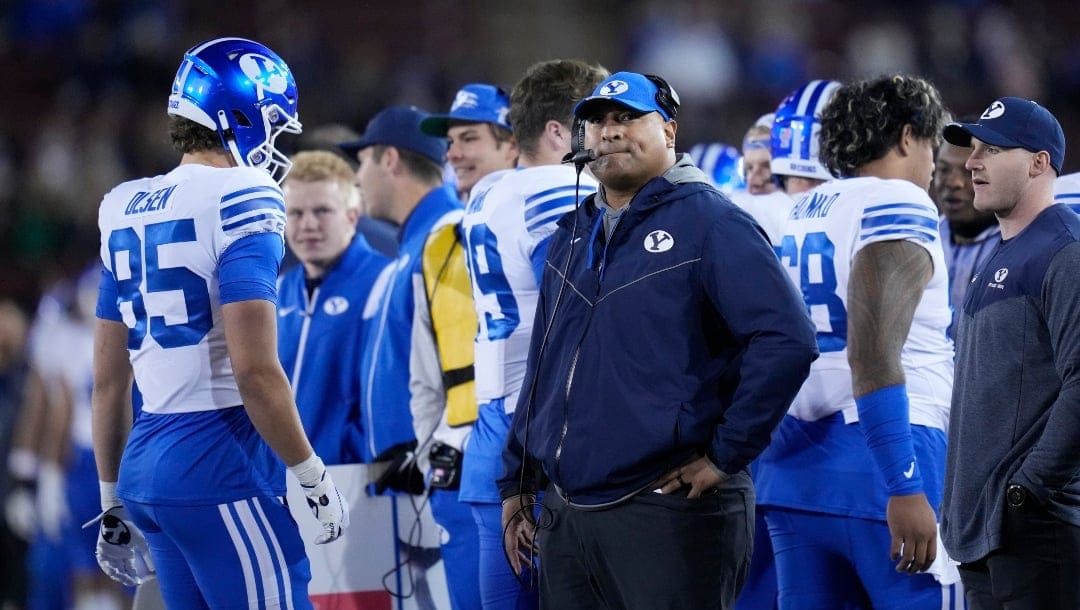 BYU coach Kalani Sitake, middle, watches during the first half of the team's NCAA college football game against Stanford in Stanford, Calif., Saturday, Nov. 26, 2022. (AP Photo/Godofredo A. Vásquez)