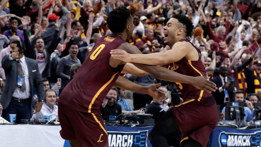 FILE - In this March 15, 2018, file photo, Loyola-Chicago guard Donte Ingram (0) and Marques Townes, right, celebrate their 64-62 win over Miami in a first-round game at the NCAA college basketball tournament in Dallas. Their run to the Final Four as an 11 seed never seemed short of drama.(AP Photo/Tony Gutierrez, File)