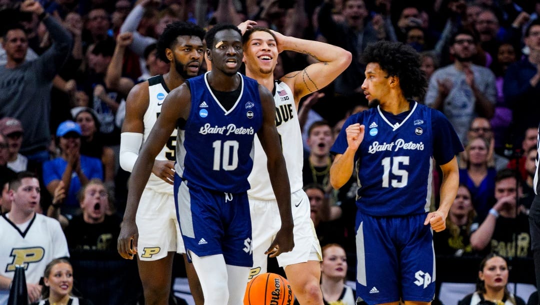 Saint Peter's Fousseyni Drame, center, reacts during the second half of a college basketball game against Purdue in the Sweet 16 round of the NCAA tournament, Friday, March 25, 2022, in Philadelphia. (AP Photo/Chris Szagola)