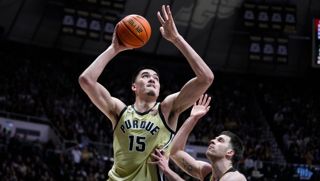 Purdue center Zach Edey (15) shoots over Iowa forward Filip Rebraca (0) during the second half of an NCAA college basketball game in West Lafayette, Ind., Thursday, Feb. 9, 2023. Purdue defeated Iowa. (AP Photo/Michael Conroy)