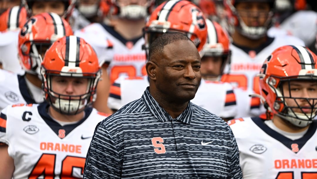 Syracuse head coach Dino Babers leads his team onto the field for an NCAA college football game against Pittsburgh, Saturday, Nov. 5, 2022, in Pittsburgh, Pa. Pittsburgh won 19-9. (AP Photo/Barry Reeger)