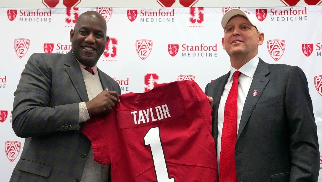 Bernard Muir, left, athletic director at Stanford, and Troy Taylor, right, Stanford's new head NCAA college football coach, pose for a photo during a news conference, Monday, Dec. 12, 2022, in Stanford, Calif. (AP Photo/Tony Avelar)