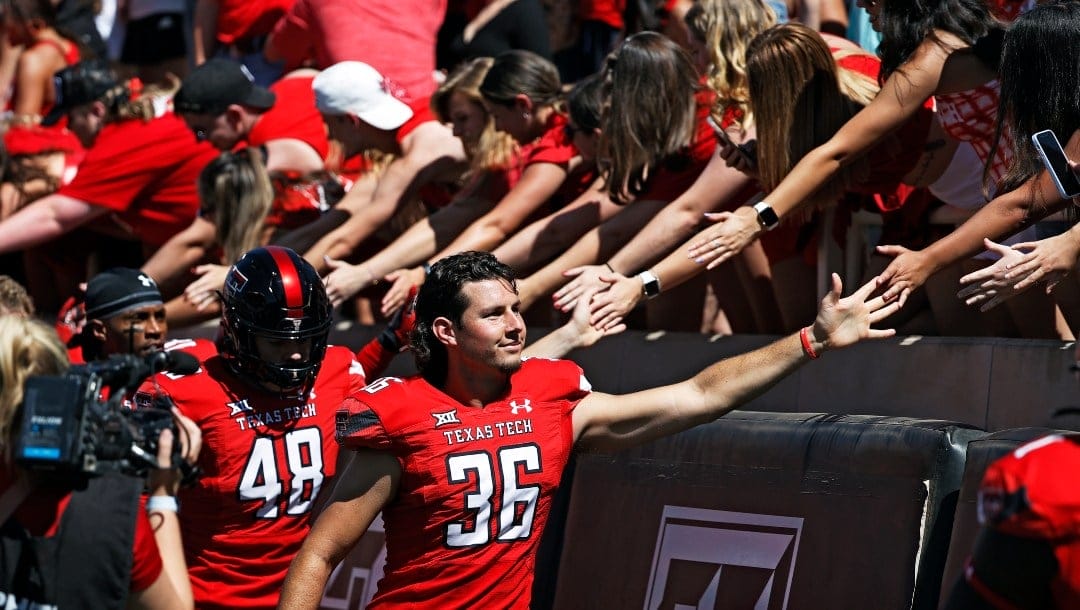 Texas Tech's Trey Wolff (36) high-fives fans before an NCAA college football game against Texas, Saturday, Sept. 24, 2022, in Lubbock, Texas. (AP Photo/Brad Tollefson)