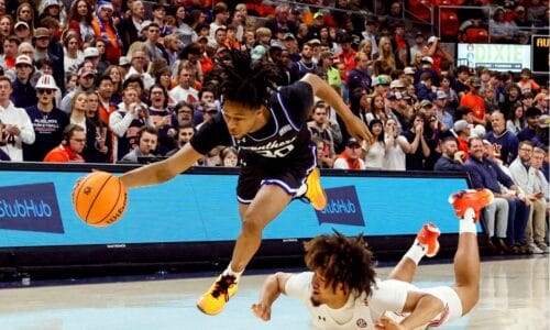 A Georgia State Panthers player dribbling the ball with an opponent falling in an attempt to defend