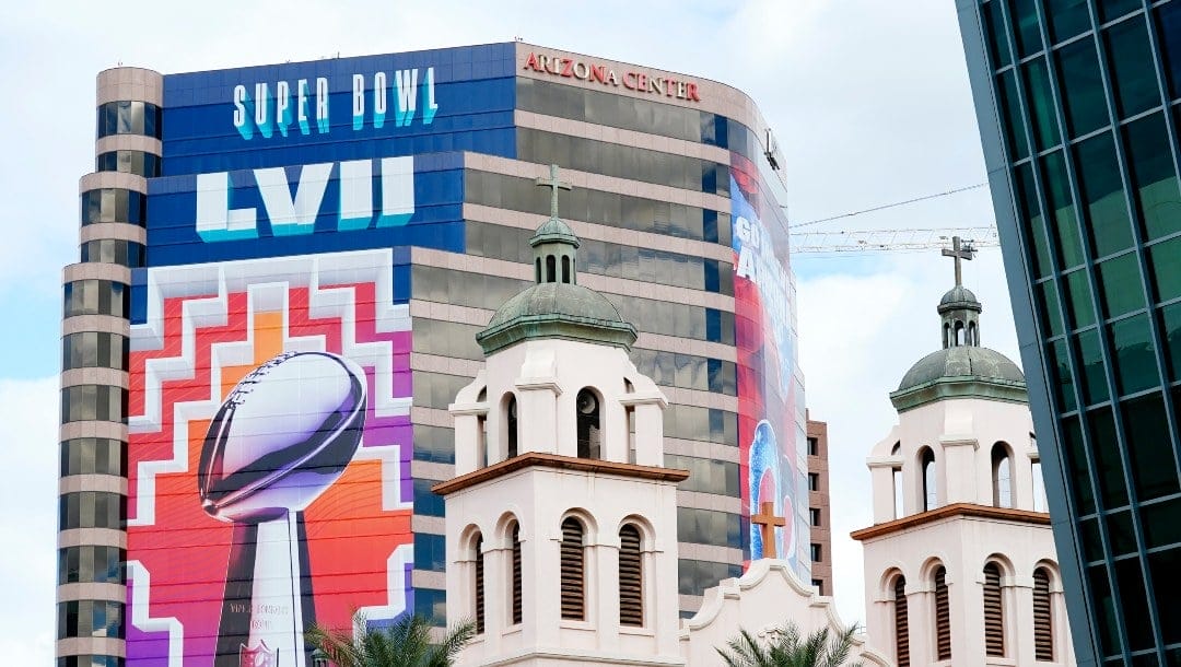 Large Super Bowl signs are on full display, dwarfing St. Mary's Basilica, leading up to the NFL Super Bowl LVII football game in Phoenix, Monday, Jan. 30, 2023. The Philadelphia Eagles and the Kansas City Chiefs will play in Super Bowl LVII on Sunday, Feb. 12, 2023. (AP Photo/Ross D. Franklin)