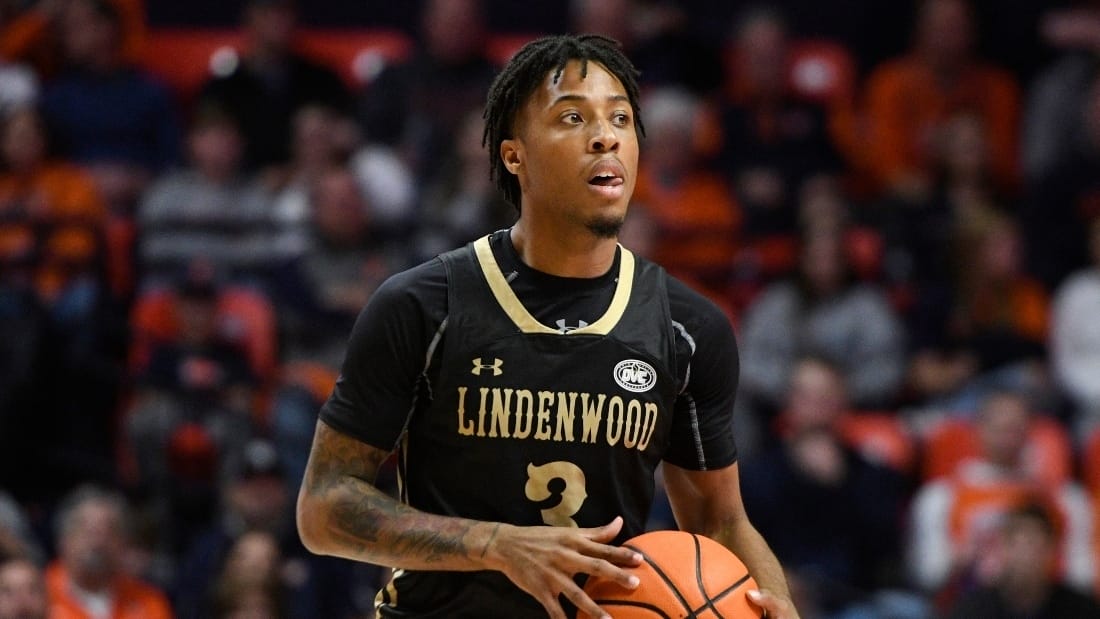 A close up of Lindenwood No 3 player with a basketball ball in his hands