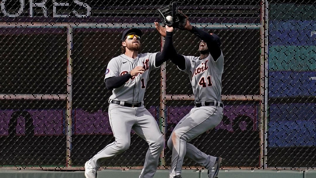 Detroit Tigers left fielder Eric Haase, left, nearly colliedes with center fielder Daz Cameron (41) as he catches a fly ball for the out on Kansas City Royals' Hunter Dozier during the third inning of a baseball game Saturday, April 16, 2022, in Kansas City, Mo.