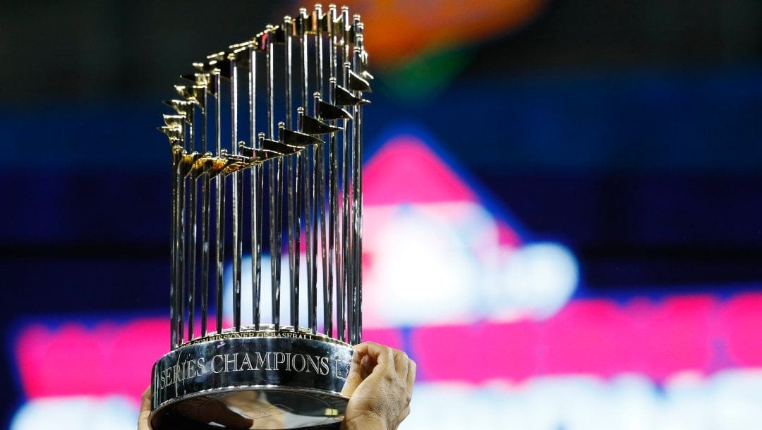 The championship trophy is held up after Game 7 of the baseball World Series between the Houston Astros and the Washington Nationals Wednesday, Oct. 30, 2019, in Houston. The Nationals won 6-2 to win the series.