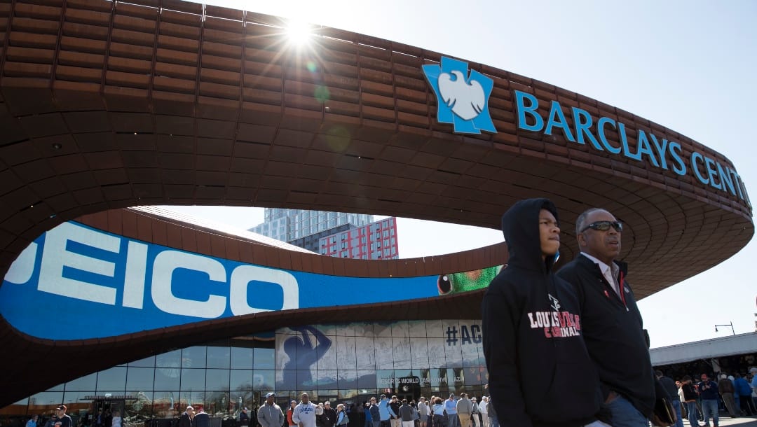 Louisville fans walk outside Barclays Center where the men's Atlantic Coast Conference NCAA college basketball tournament is taking place, Thursday, March 9, 2017, in New York. ACC Commissioner John Swofford insists bringing the league's storied men's basketball tournament to Brooklyn is not an experiment, but the start of a long-term relationship. Still, this is a long way to go for the hardcore hoops fans of the ACC's power schools, who have grown a bit possessive of this tournament down South.(AP Photo/Mary Altaffer)