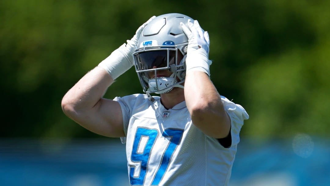 Detroit Lions defensive end Aidan Hutchinson stretches during an NFL football practice in Allen Park, Mich., Thursday, May 25, 2023. (AP Photo/Paul Sancya)
