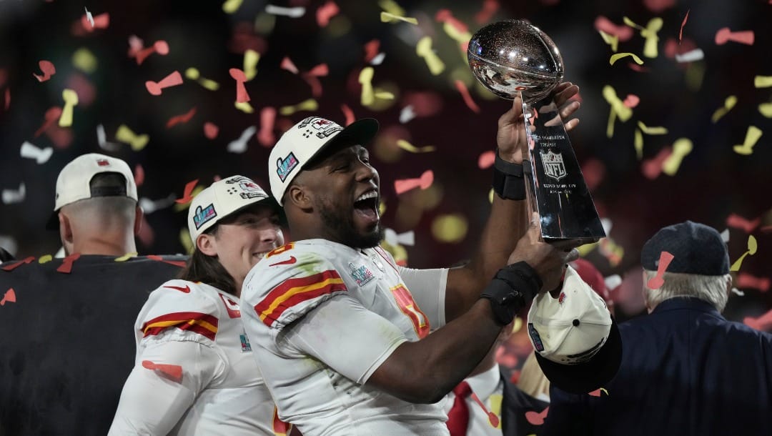 Kansas City Chiefs defensive end Carlos Dunlap poses with the Vince Lombardi Trophy after the NFL Super Bowl 57 football game, Sunday, Feb. 12, 2023, in Glendale, Ariz. (AP Photo/Doug Benc)