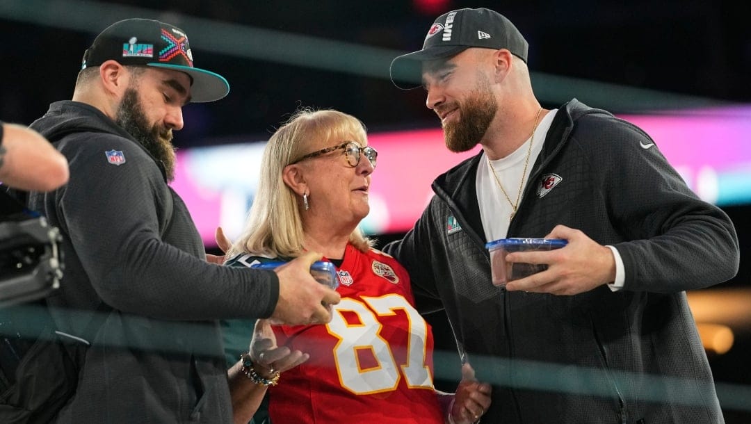 Donna Kelce greets her sons, Philadelphia Eagles center Jason Kelce, left, and Kansas City Chiefs tight end Travis Kelce