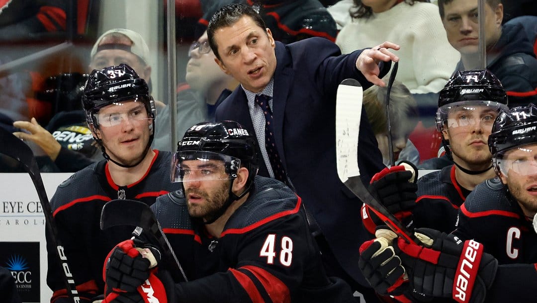 Carolina Hurricanes head coach Rod Brind'Amour speaks with Andrei Svechnikov (37) and Jordan Martinook (48) during the second period of an NHL hockey game against the Pittsburgh Penguins in Raleigh, N.C., Saturday, Jan. 14, 2023.