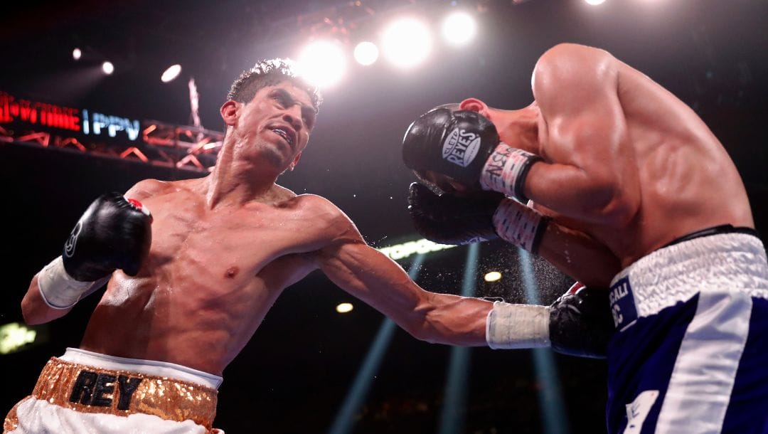 Rey Vargas, of Mexico, hits Leonardo Baez, of Mexico, during a featherweight boxing match Saturday, Nov. 6, 2021, in Las Vegas.