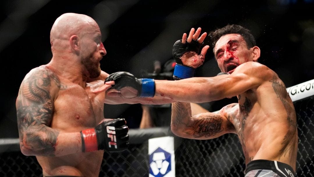 Alexander Volkanovski, left, fights Max Holloway in a featherweight title bout during the UFC 276 mixed martial arts event.