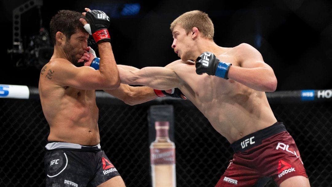 Gilbert Melendez, left, takes a right from Arnold Allen during their featherweight mixed martial arts bout at UFC 239.