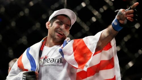 Beneil Dariush points to the crowd in celebration after defeating Daron Cruickshank in two rounds during a men's lightweight UFC bout.