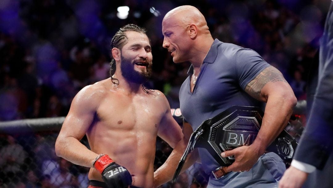 Jorge Masvidal, left, talks to Dwayne "The Rock" Johnson after a welterweight mixed martial arts bout against Nate Diaz at UFC 244.