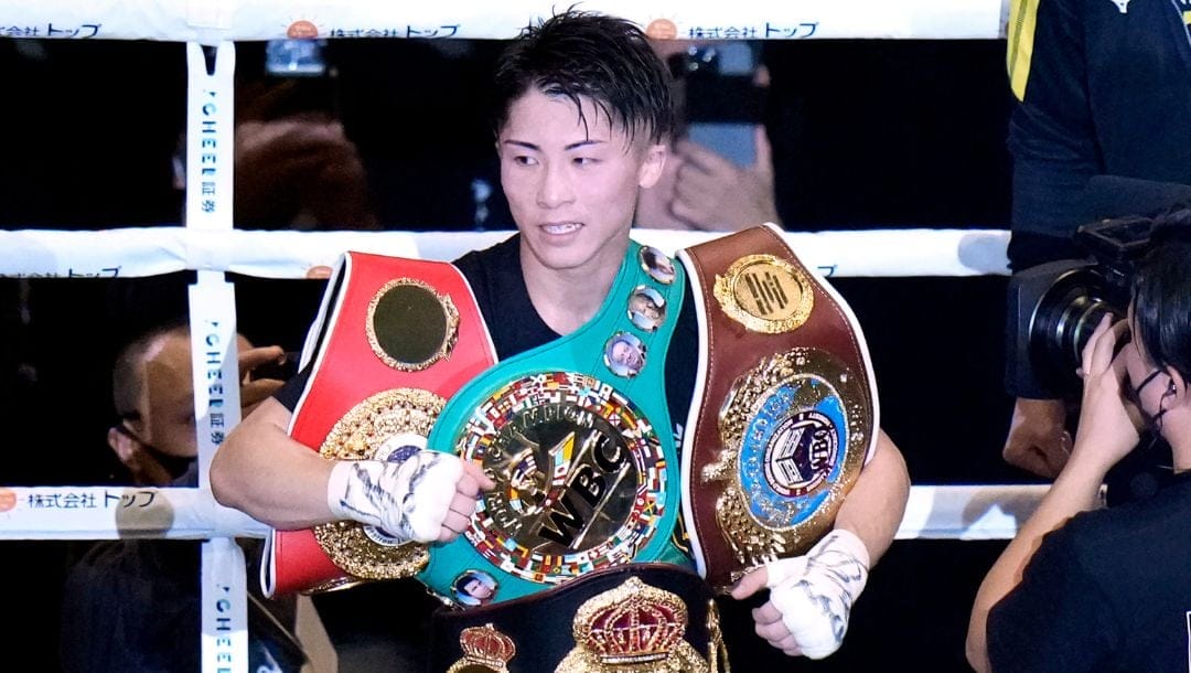 Naoya Inoue of Japan celebrates with his four champion belts, after defeating Paul Butler of Britain after their bantamweight title.