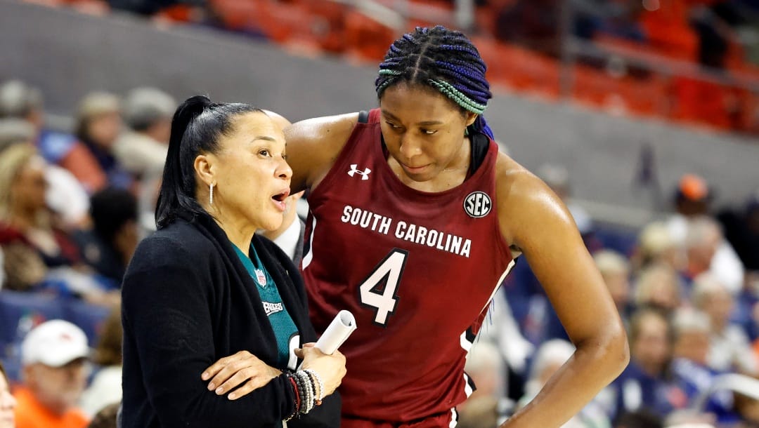 FILE - South Carolina head coach Dawn Staley, left, talks with forward Aliyah Boston (4) during the second half of an NCAA college basketball game against Auburn, on Feb. 9, 2023, in Auburn, Ala. One thing's nearly certain when LSU's Angel Reese and South Carolina's Aliyah Boston face off Sunday in a showdown of the country's last two undefeated teams: Someone, if not both, will come away with a double-double. (AP Photo/Butch Dill, FIle)