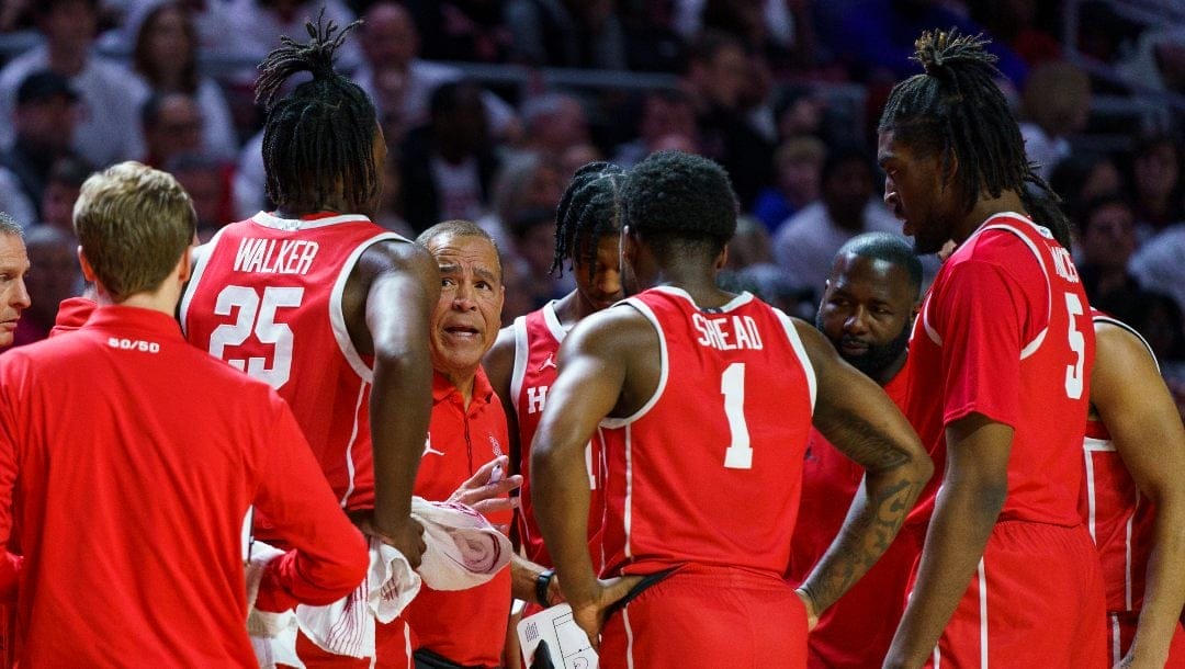 Houston head coach Kelvin Sampson, third from left, talks with his team during the first half of an NCAA college basketball game against Temple, Sunday, Feb. 5, 2023, in Philadelphia.