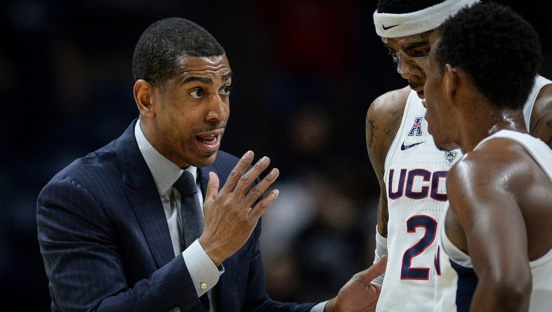 Connecticut head coach Kevin Ollie, left, talks with Connecticut's Terry Larrier and Christian Vital, right, during an NCAA college basketball game, Wednesday, Feb. 7, 2018, in Storrs, Conn.