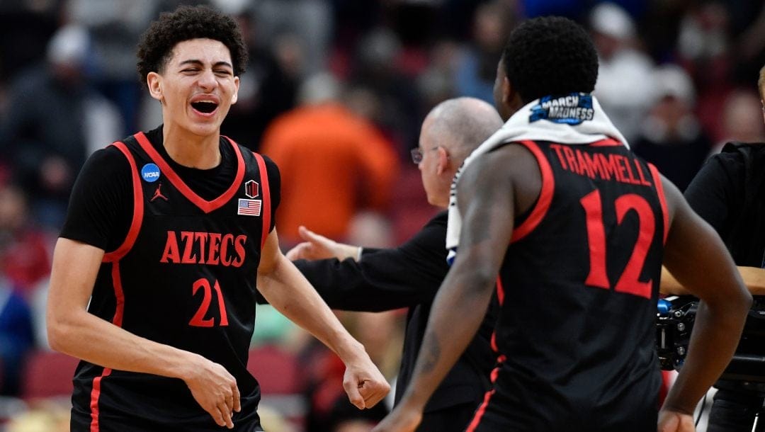 San Diego State's Miles Byrd (21) and Darrion Trammell (12) celebrate a win over Alabamaa in the second half of a Sweet 16 round college basketball game in the South Regional of the NCAA Tournament, Friday, March 24, 2023, in Louisville, Ky. San Diego State won 71-64.