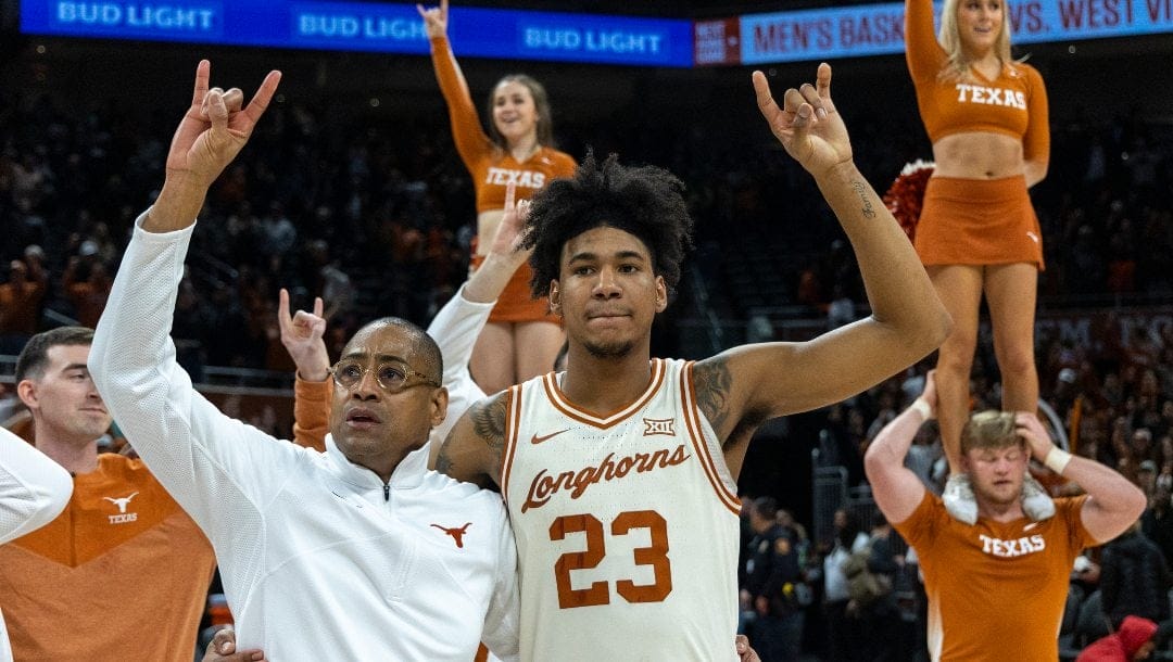 Texas interim head coach Rodney Terry and forward Dillon Mitchell (23) celebrate a win against Baylor during an NCAA college basketball game Monday, Jan. 30, 2023, in Austin, Texas.