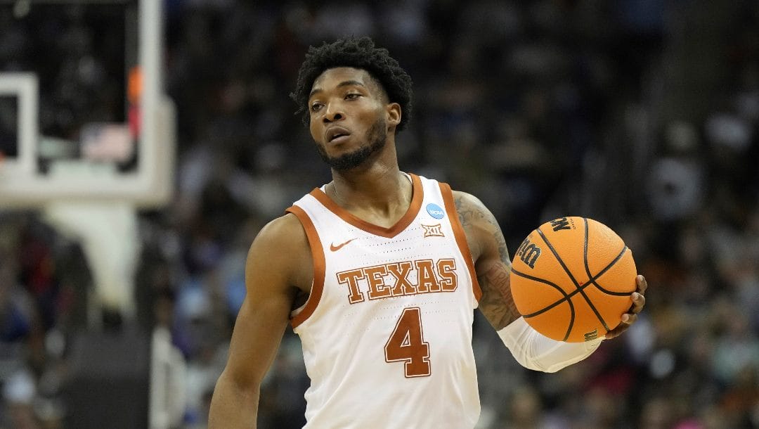 Texas guard Tyrese Hunter brings the ball down court Xavier in the first half of a Sweet 16 college basketball game in the Midwest Regional of the NCAA Tournament Friday, March 24, 2023, in Kansas City, Mo.