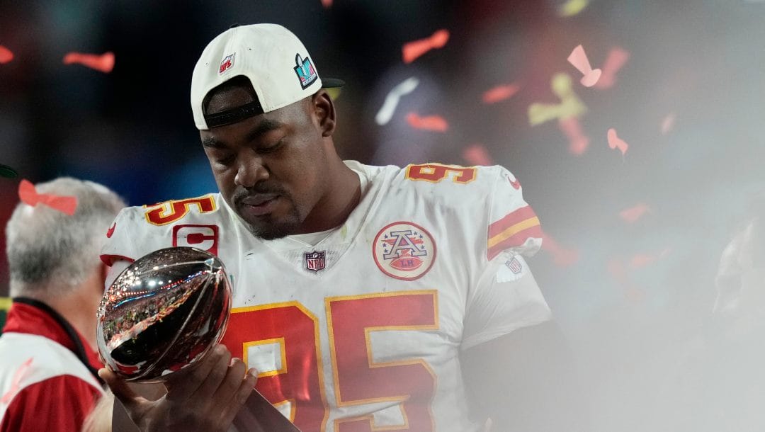 Kansas City Chiefs defensive tackle Chris Jones (95) admires the Vince Lombardi Trophy after defeating the Philadelphia Eagles in the NFL Super Bowl 57 football game, Sunday, Feb. 12, 2023, in Glendale, Ariz. The Kansas City Chiefs defeated the Philadelphia Eagles 38-35.