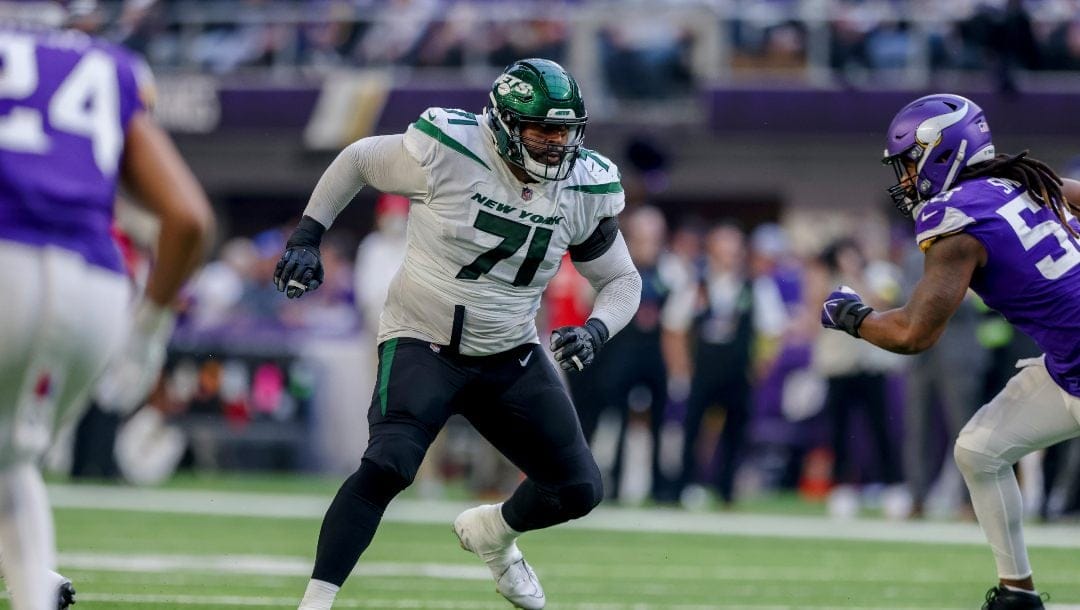 New York Jets offensive tackle Duane Brown (71) in action against the Minnesota Vikings during the second half of an NFL football game Sunday, Dec. 4, 2022 in Minneapolis.