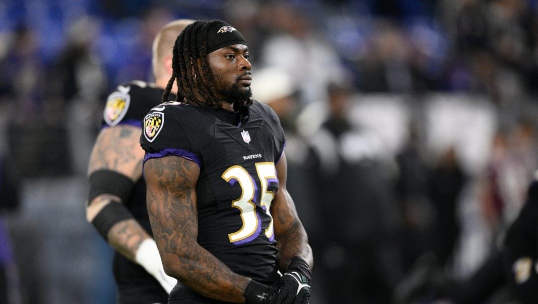 Baltimore Ravens running back Gus Edwards (35) warms up before an NFL football game against the Pittsburgh Steelers, Sunday, Jan. 1, 2023, in Baltimore.