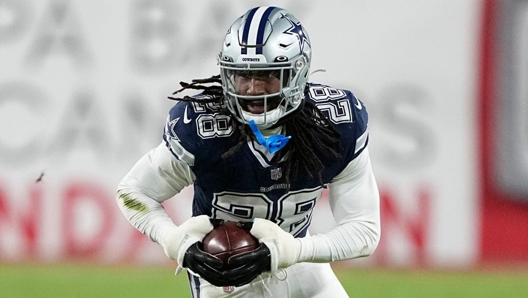 Dallas Cowboys safety Malik Hooker (28) runs after picking up a fumble against the Tampa Bay Buccaneers during the second half of an NFL wild-card football game, Monday, Jan. 16, 2023, in Tampa, Fla. The fumble was over ruled on a replay.