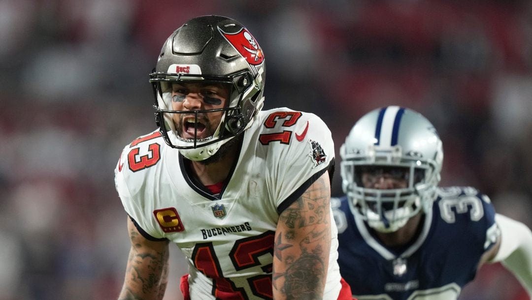 Tampa Bay Buccaneers wide receiver Mike Evans (13) grimaces after dropping a would-be touchdown as Dallas Cowboys cornerback Xavier Rhodes (39) defends during an NFL wild-card football game , Monday, Jan. 16, 2023, in Tampa, Fla.