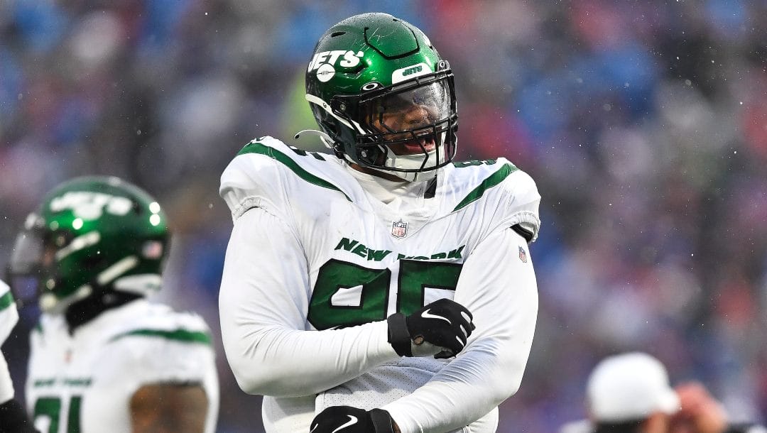 New York Jets defensive lineman Quinnen Williams (95) celebrates after sacking Buffalo Bills quarterback Josh Allen during the first half of an NFL football game in Orchard Park, N.Y., Sunday, Dec. 11, 2022.