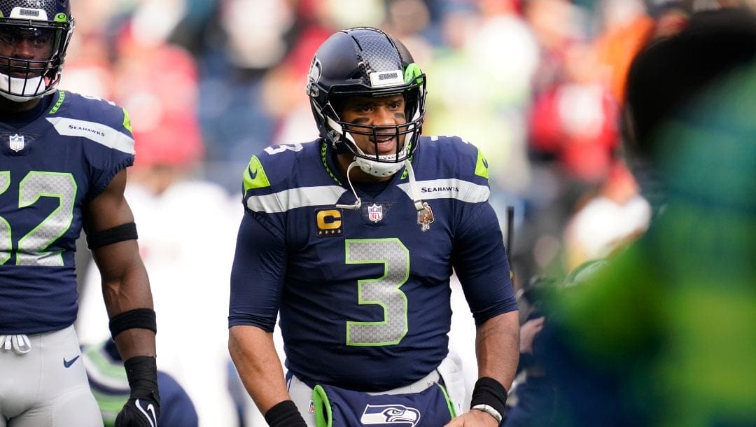 Seattle Seahawks quarterback Russell Wilson stands on the field before an NFL football game against the San Francisco 49ers, Sunday, Dec. 5, 2021, in Seattle.