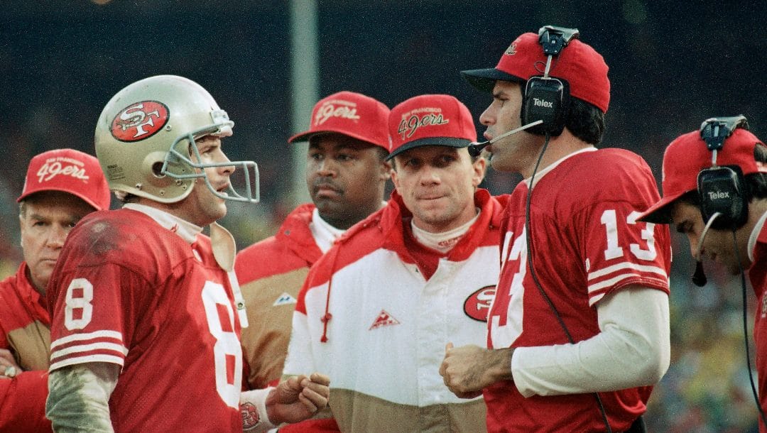 San Francisco quarter backs Steve Young, left, Joe Montana and Steve Bono, right; hold court along the sideline as time ran down in the Niners' 30-20 NFC championship loss to the Dallas Cowboys at Candlestick Park, Sunday, Jan. 18, 1993 in San Francisco. Montana spent what was probably his last game as a San Francisco 49er as a mere sideline spectator. Montana never got to warm up much less lead another of his miracle comebacks.