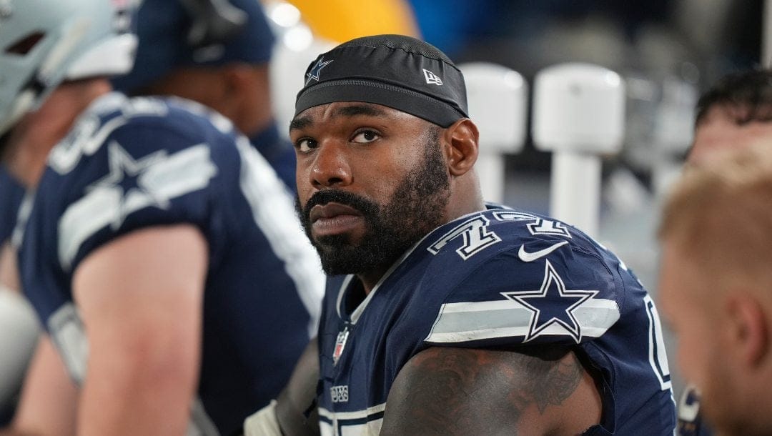 Dallas Cowboys offensive tackle Tyron Smith (77) watches the video board from the bench during an NFL wild-card football game against the Tampa Bay Buccaneers, Monday, Jan. 16, 2023, in Tampa, Fla.
