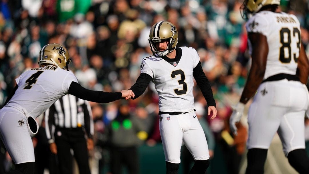 New Orleans Saints holder Blake Gillikin (4) congratulates place kicker Wil Lutz (3) after kicking a field goal in the first half of an NFL football game against the Philadelphia Eagles in Philadelphia, Sunday, Jan. 1, 2023
