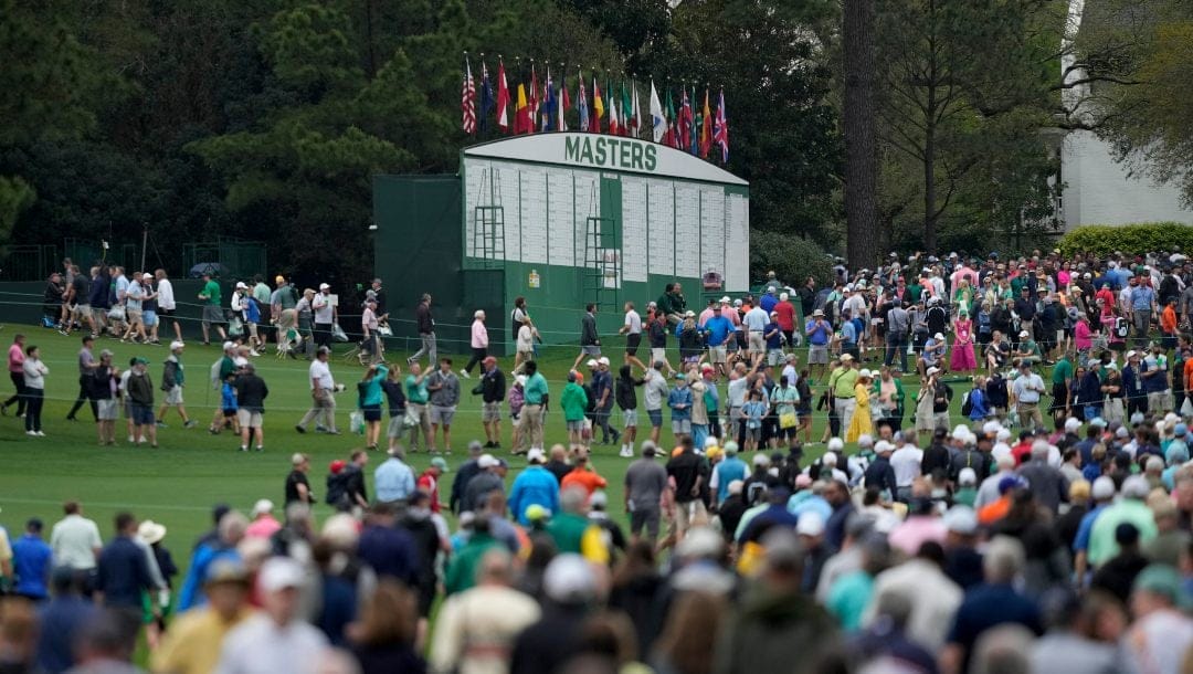 Spectators leave Augusta National Golf Course after a weather warning was issued during a practice round at the Masters golf tournament on Wednesday, April 6, 2022, in Augusta, Ga.