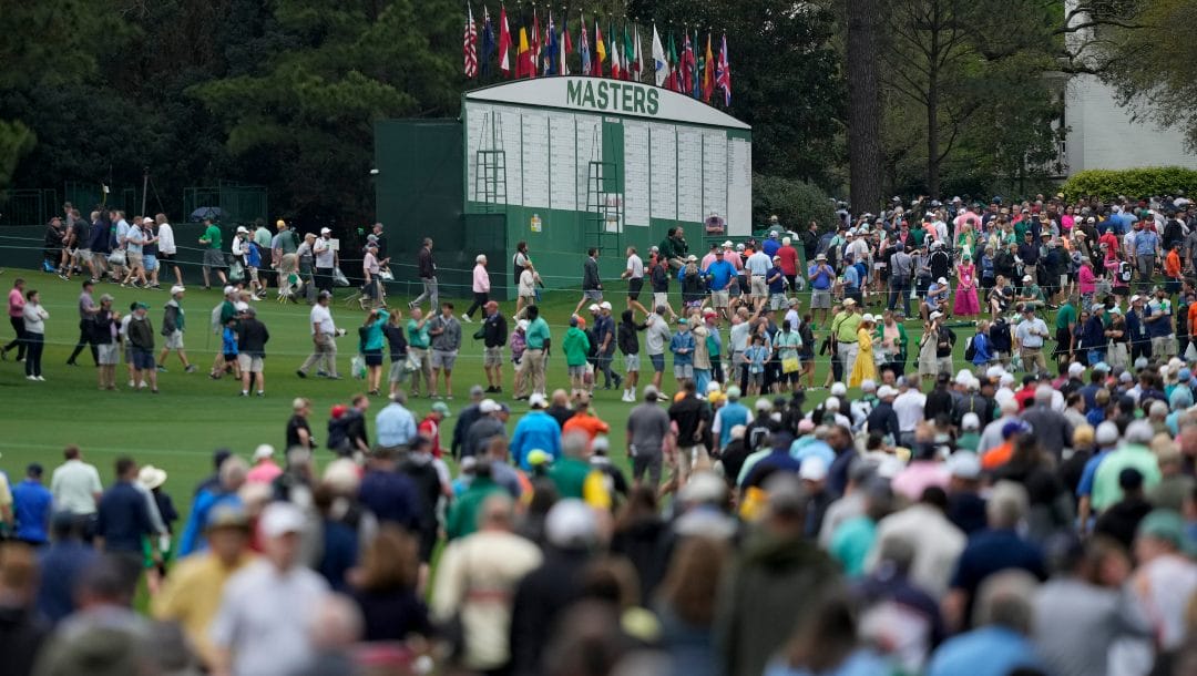 Spectators leave Augusta National Golf Course after a weather warning was issued during a practice round at the Masters golf tournament on Wednesday, April 6, 2022, in Augusta, Ga.