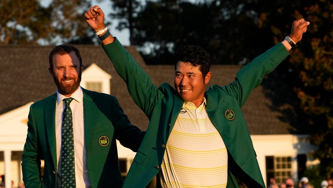 In this Sunday, April 11, 2021 file photo, Hideki Matsuyama, of Japan, puts on the champion's green jacket after winning the Masters golf tournament as Dustin Johnson watches in Augusta, Ga.