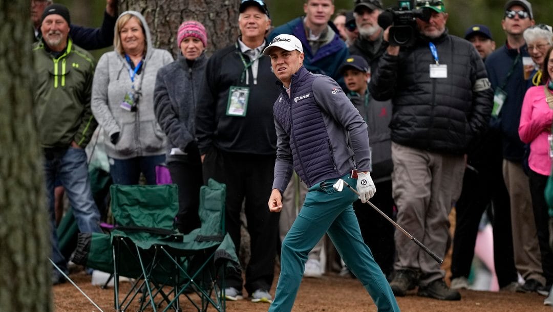 Justin Thomas watches his shot from the pine straw on the first fairway during the third round at the Masters golf tournament on Saturday, April 9, 2022, in Augusta, Ga.