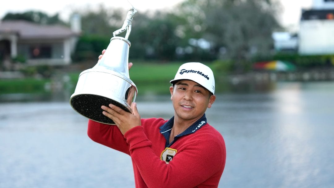 Kurt Kitayama holds the championship trophy after winning the Arnold Palmer Invitational golf tournament Sunday, March 5, 2023, in Orlando, Fla.