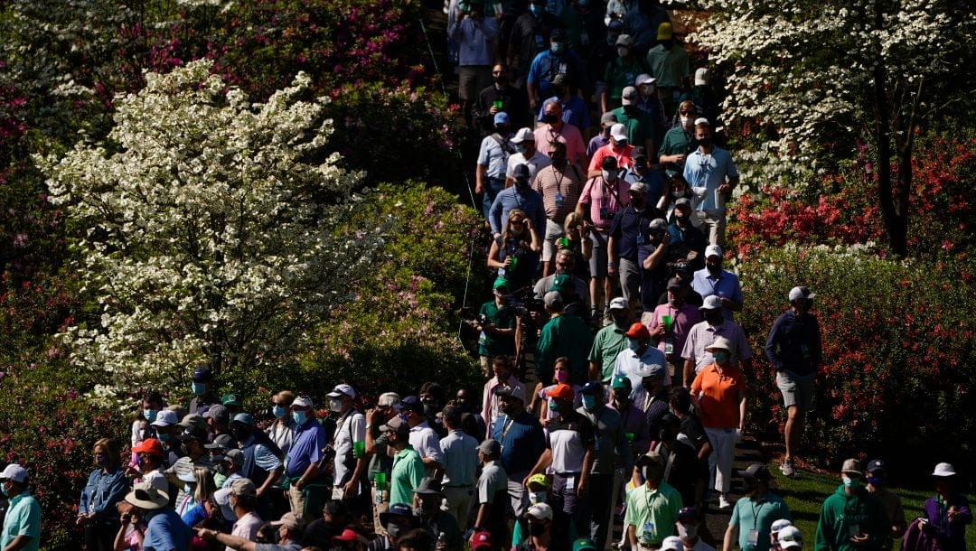 Patrons walk along the path on the sixth hole during a practice round for the Masters golf tournament on Monday, April 5, 2021, in Augusta, Ga.